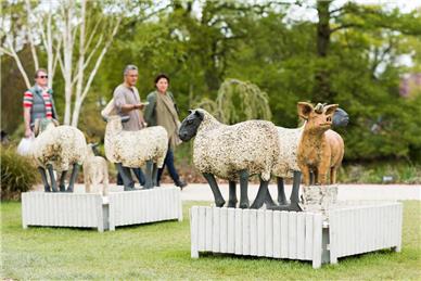 Visitors looking at life-sized sculptures of sheep and pig  - Spring Craft Fair