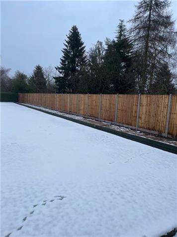 a wintry view of the new fence - Club Improvements For 2021