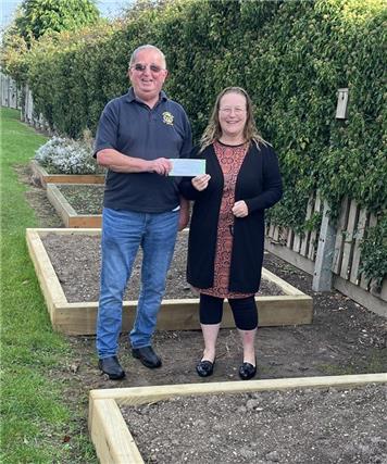 Pete Butler handing over the vouchers to Mrs Gower for there garden projects at Halton Holegate - Donations to Primary Schools