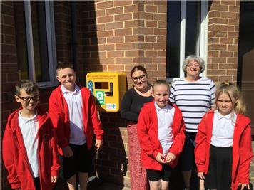 Representatives from the primary school and Methodist chapel unveiling the defibrillator  - Life saving defibrillators installed in Bearpark